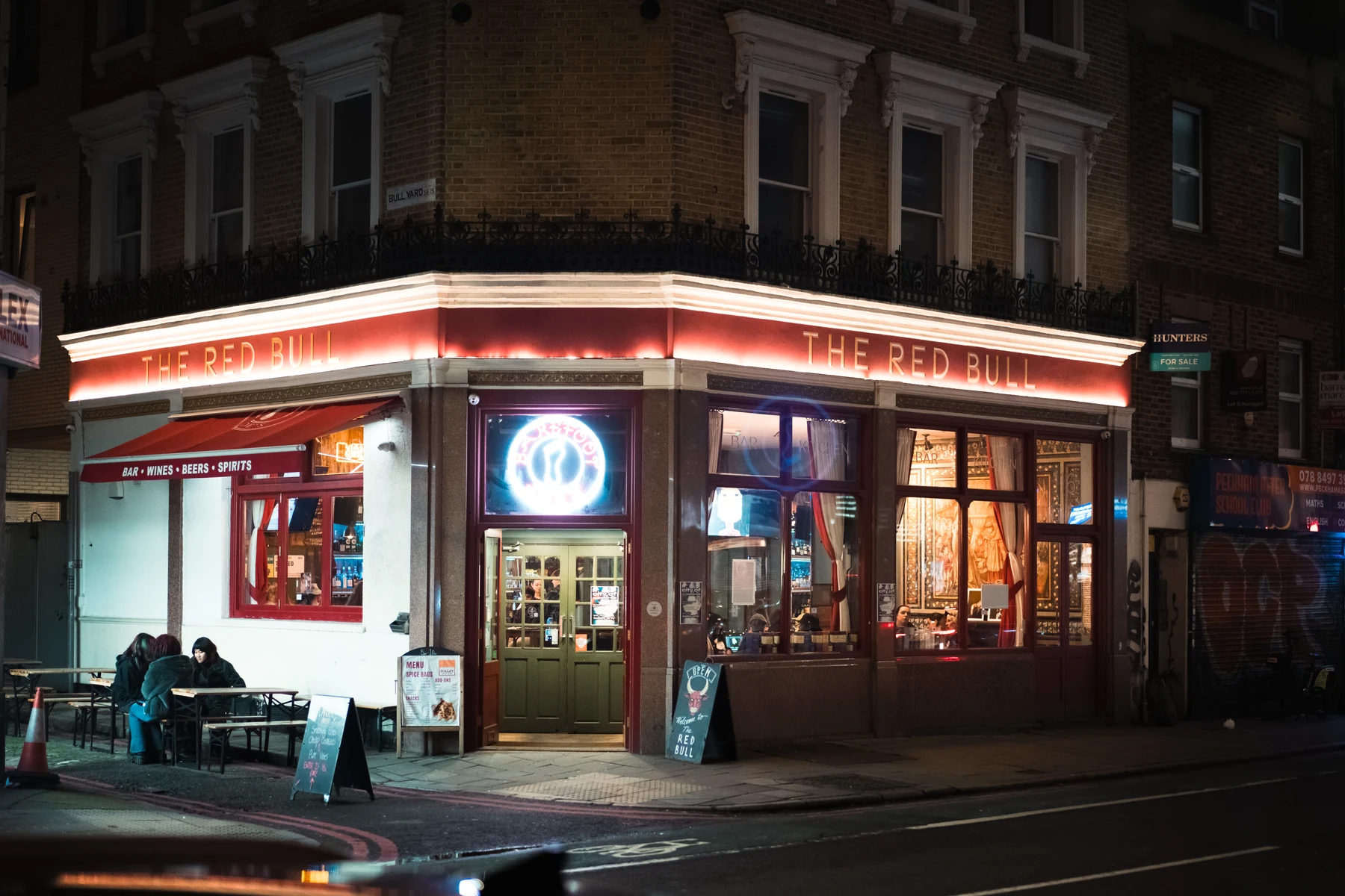 Long-exposure nighttime view of a London pub and its illuminated frontage