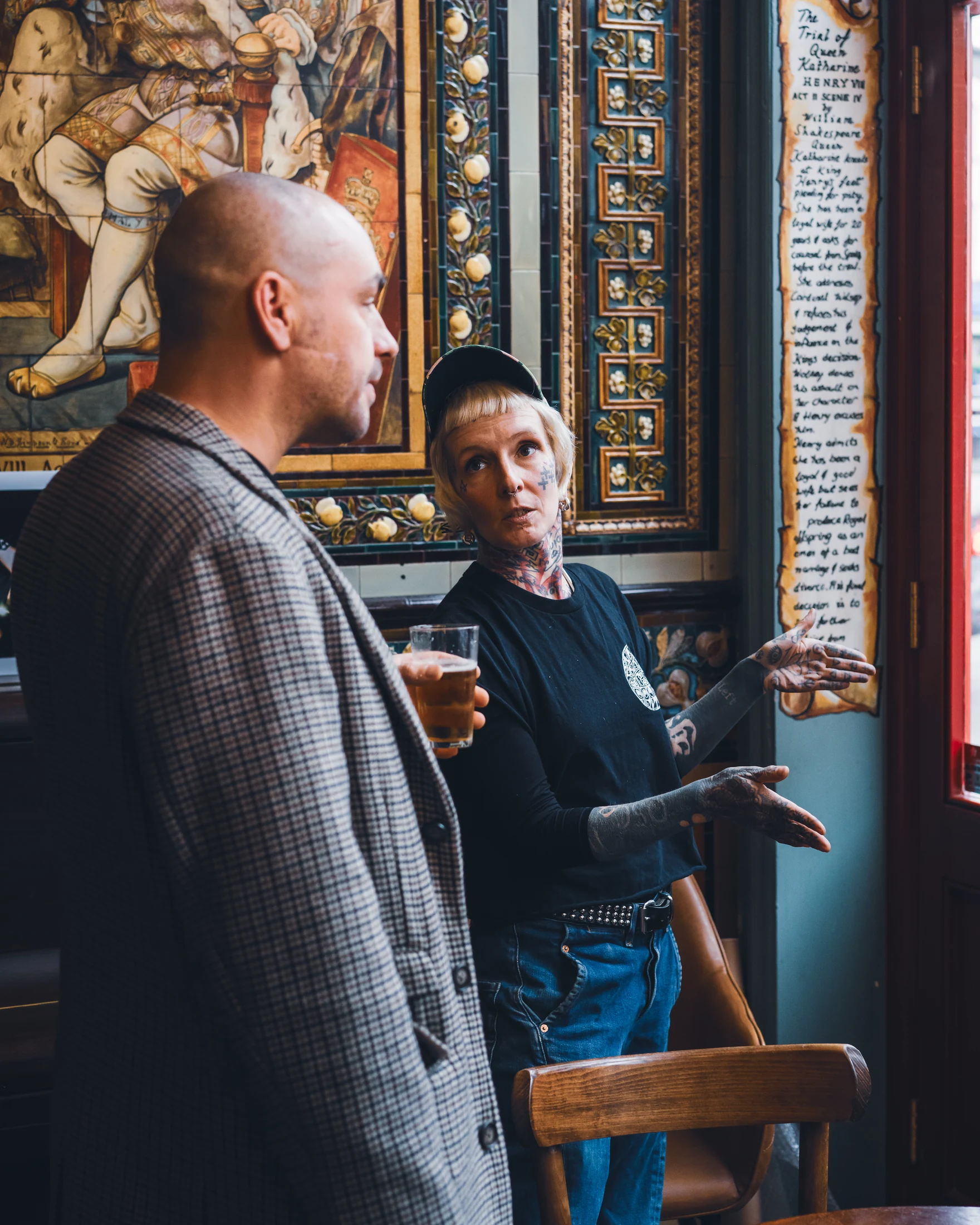 Two people speaking inside an ornate hospitality venue