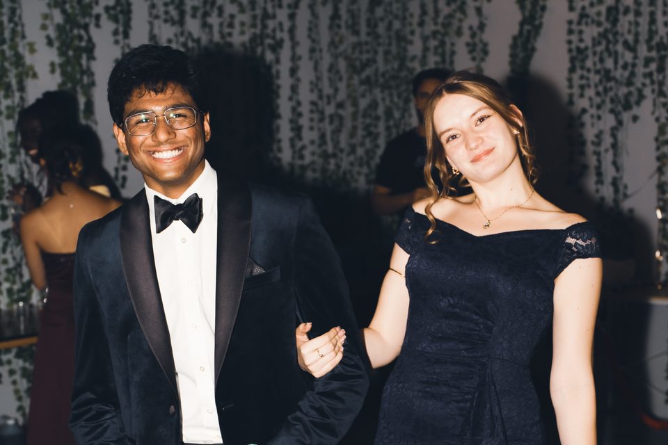 Two formally dressed individuals at an indoor event.